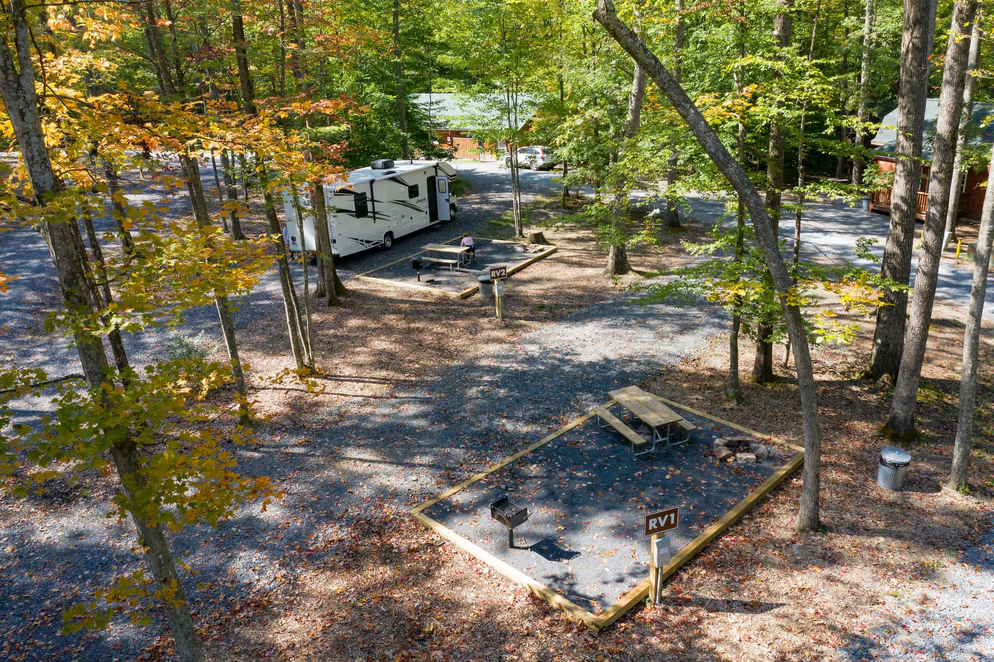 An aerial view of an RV in the woods