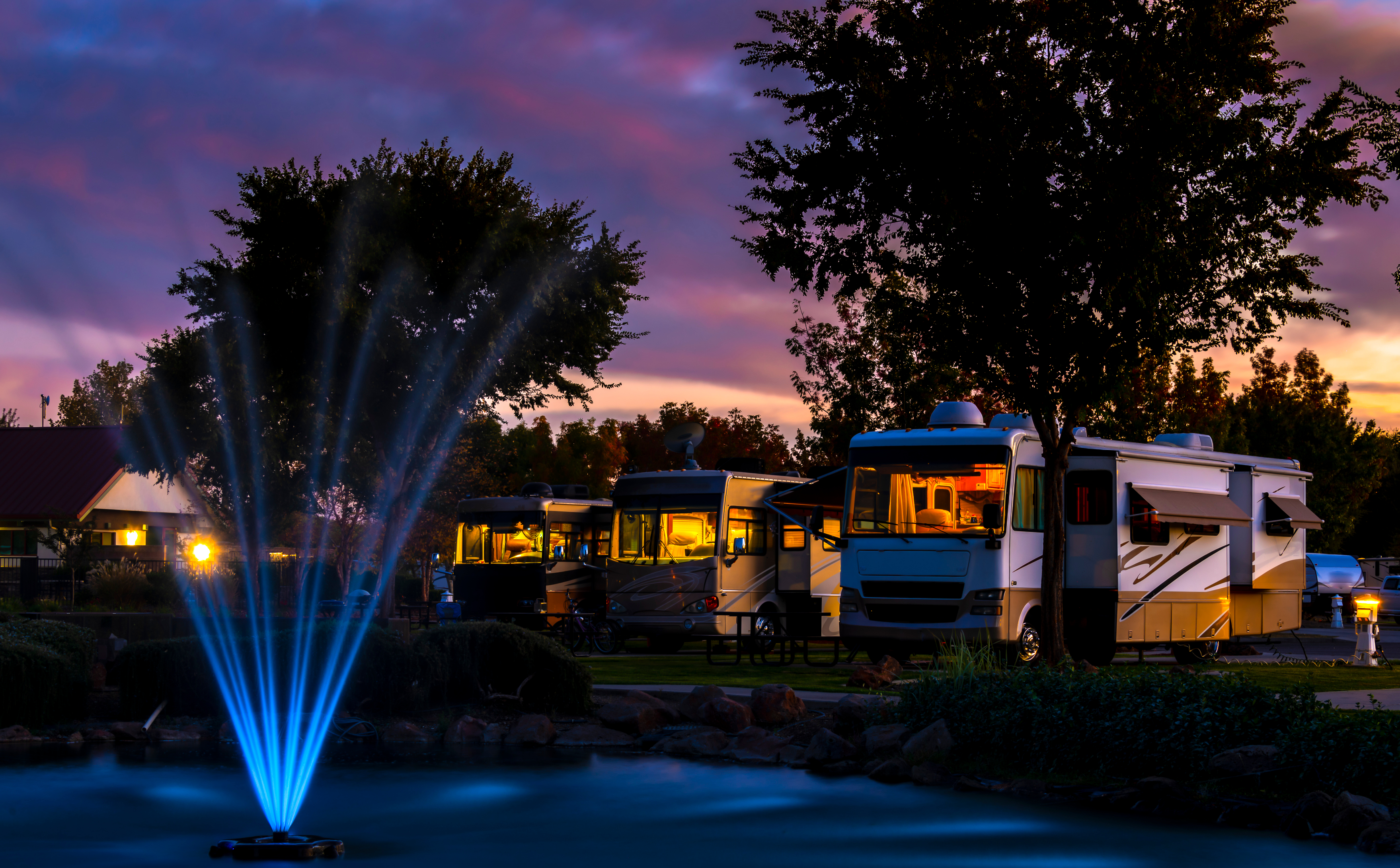 Motorhomes lined up at a campground resort at dusk